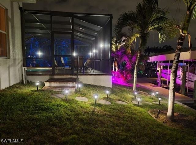 yard at twilight featuring a sunroom