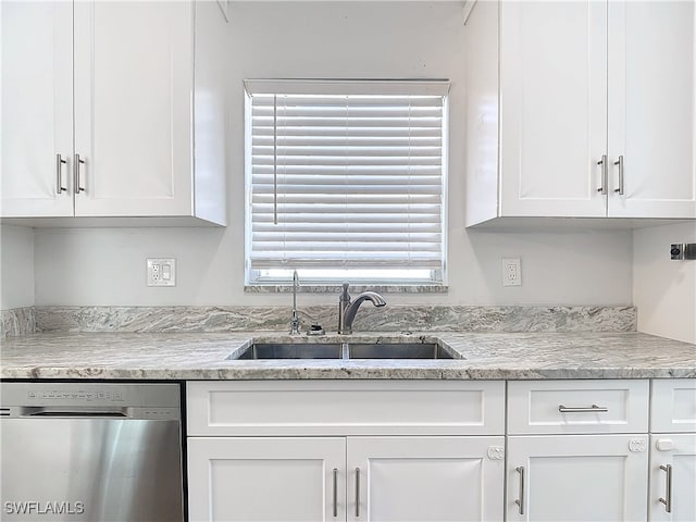 kitchen with dishwasher, sink, and white cabinets