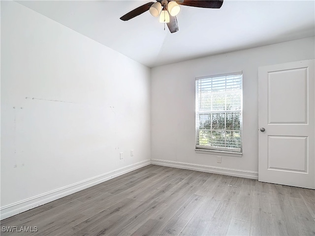 unfurnished room with ceiling fan, light wood-type flooring, and lofted ceiling