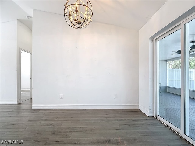 unfurnished dining area with ceiling fan with notable chandelier and dark wood-type flooring