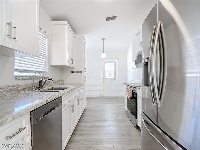 kitchen featuring plenty of natural light, sink, white cabinetry, and stainless steel appliances