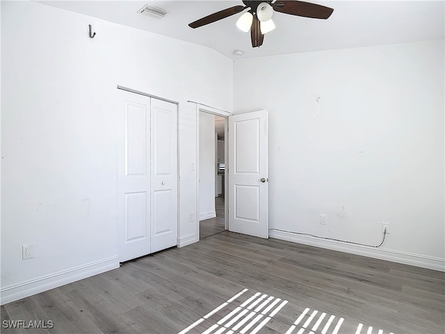 unfurnished bedroom featuring ceiling fan, hardwood / wood-style floors, and lofted ceiling