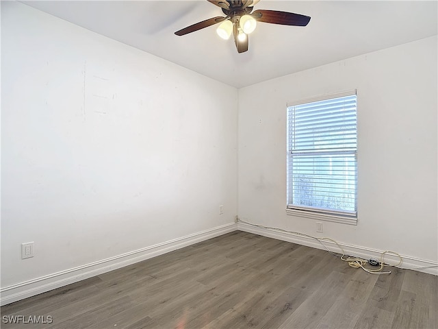 empty room featuring dark hardwood / wood-style floors and ceiling fan