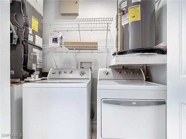 clothes washing area with washing machine and clothes dryer and water heater