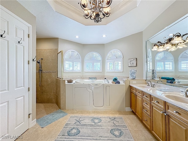 bathroom featuring ornamental molding, vanity, an inviting chandelier, independent shower and bath, and tile patterned flooring