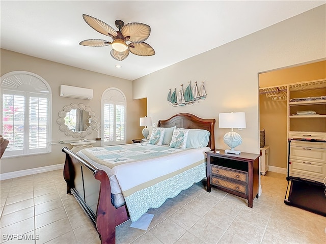 tiled bedroom with ceiling fan, a closet, a wall mounted AC, and multiple windows