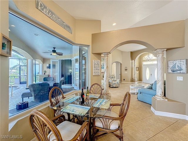 tiled dining area featuring ceiling fan, ornate columns, and lofted ceiling