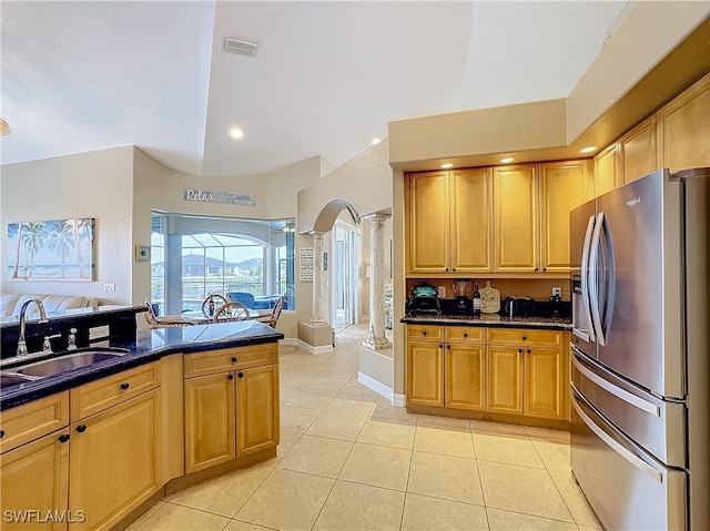 kitchen with light tile patterned flooring, sink, ornate columns, and stainless steel refrigerator with ice dispenser