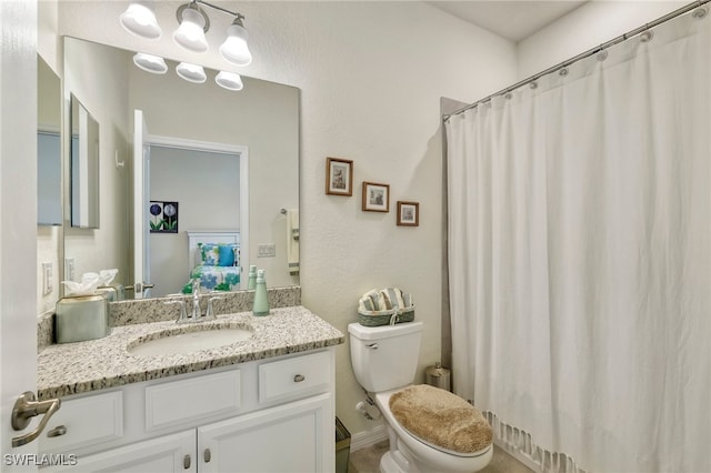 bathroom featuring toilet and vanity