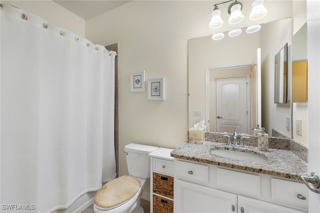 bathroom with toilet and vanity