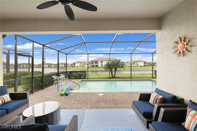 view of pool featuring ceiling fan, a patio, glass enclosure, and outdoor lounge area