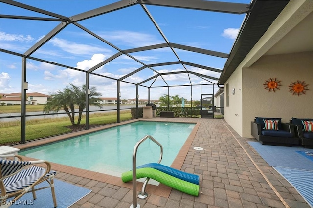 view of pool featuring a lanai, outdoor lounge area, and a patio