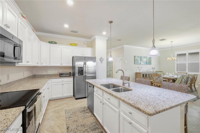 kitchen featuring stainless steel appliances, a sink, crown molding, white cabinets, and light stone counters
