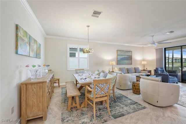 dining room featuring ceiling fan, ornamental molding, and light tile patterned flooring