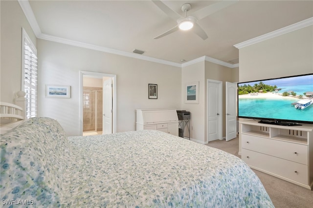 carpeted bedroom featuring ceiling fan, crown molding, and ensuite bath