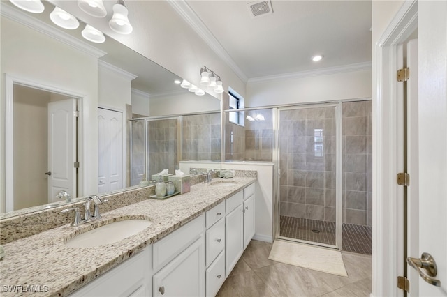 bathroom with crown molding, an enclosed shower, tile patterned floors, and vanity