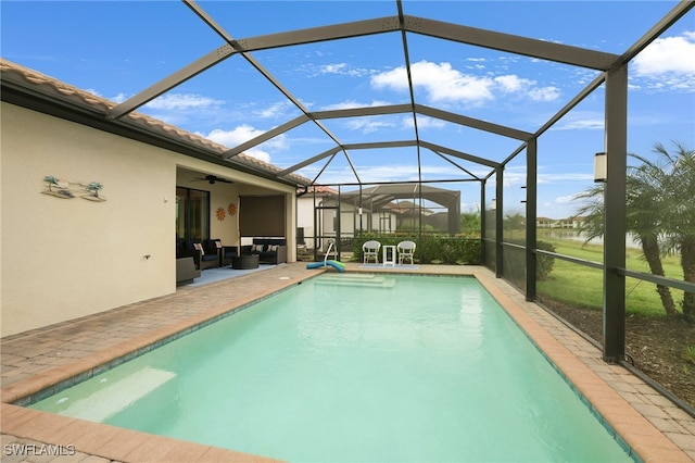 view of swimming pool with a lanai, ceiling fan, an outdoor living space, and a patio area