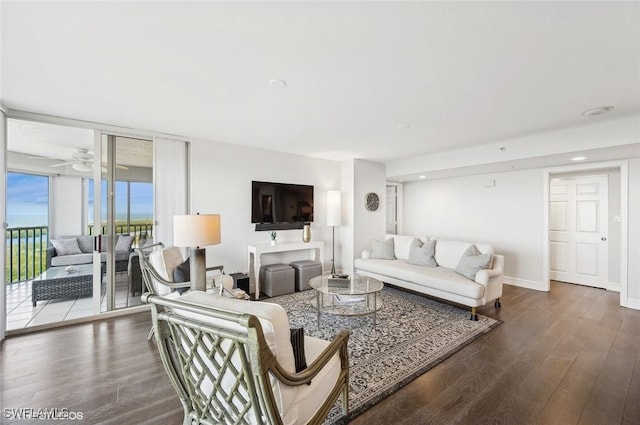 living room featuring wood-type flooring, expansive windows, and ceiling fan