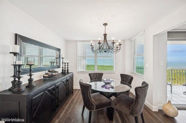 dining room featuring dark hardwood / wood-style flooring and a chandelier