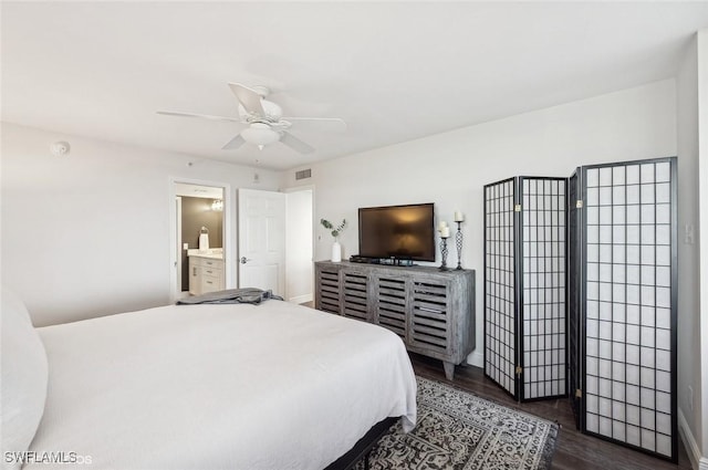 bedroom with ensuite bath, ceiling fan, and dark hardwood / wood-style floors