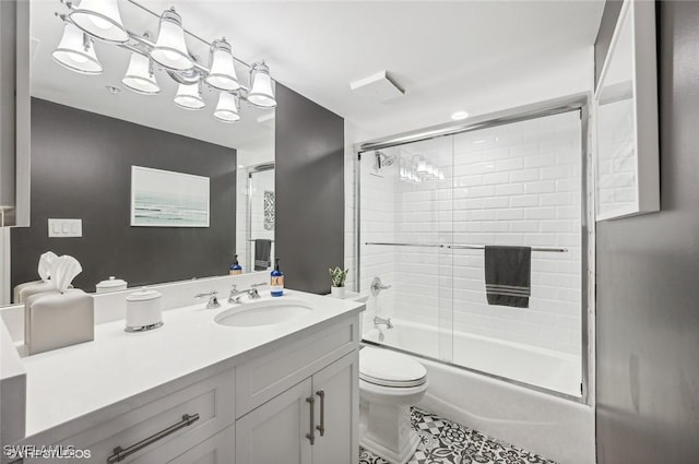 full bathroom featuring tile patterned floors, vanity, toilet, and enclosed tub / shower combo