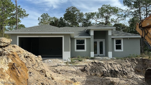 view of front of home featuring a garage and french doors