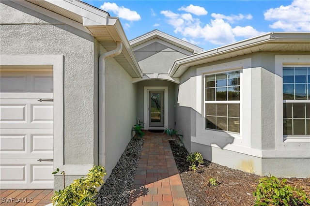 doorway to property with a garage