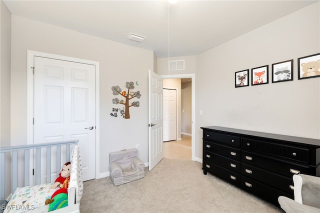 carpeted bedroom featuring a crib