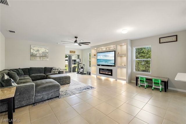 living room with ceiling fan and light tile patterned flooring