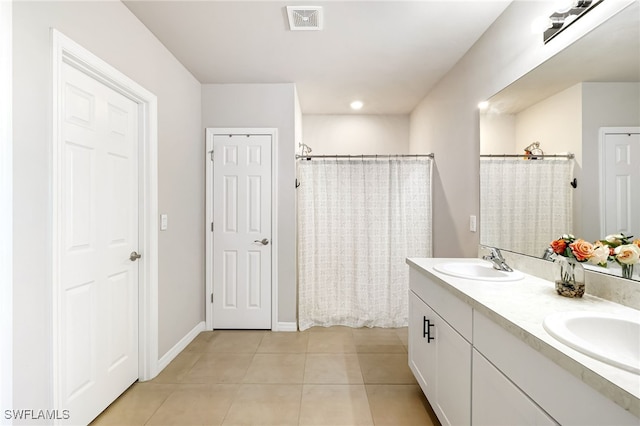 bathroom with curtained shower, tile patterned flooring, and vanity