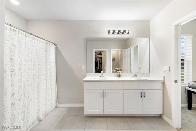 bathroom with a wealth of natural light, tile patterned flooring, and vanity