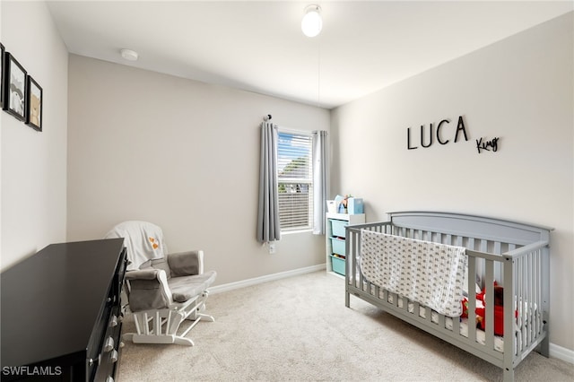 carpeted bedroom with a crib