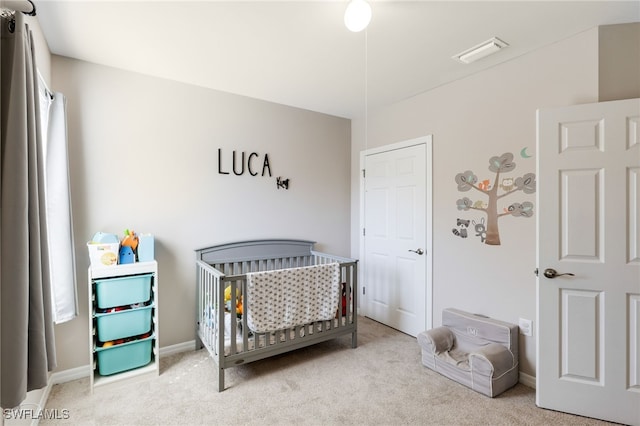 carpeted bedroom with a crib