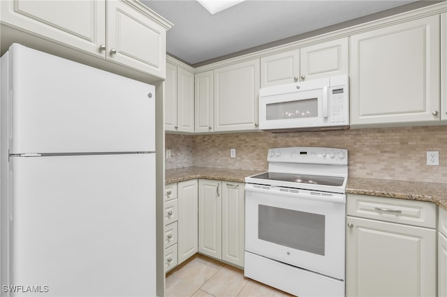 kitchen with light stone counters, light tile patterned floors, backsplash, white cabinets, and white appliances