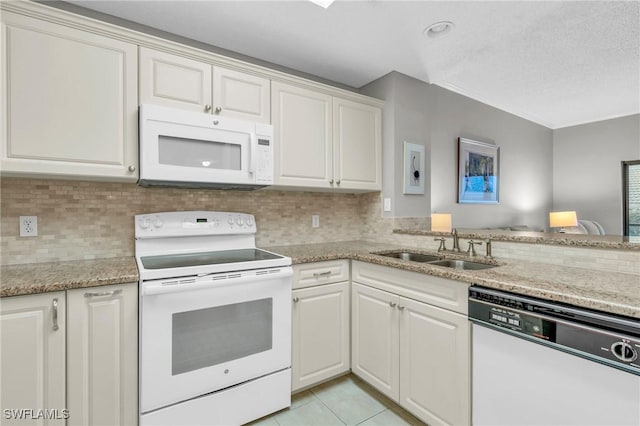 900 Arbor Lake Dr Unit 9-101, Naples, FL 34110 - kitchen with white appliances, a sink, backsplash, light tile patterned floors, and light stone countertops