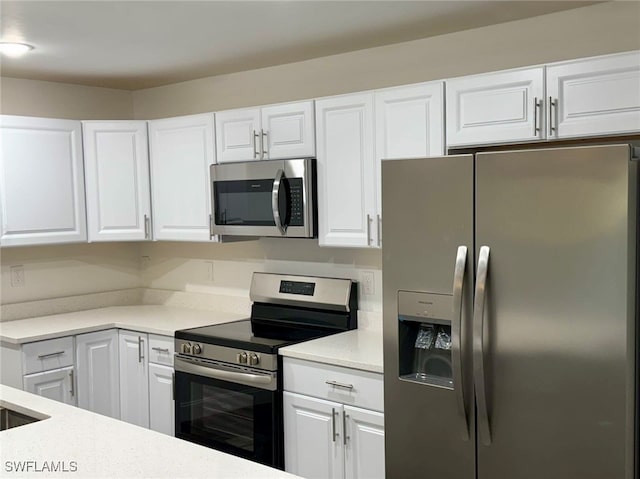 kitchen featuring white cabinets and appliances with stainless steel finishes