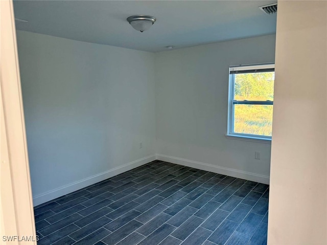 empty room with dark hardwood / wood-style flooring