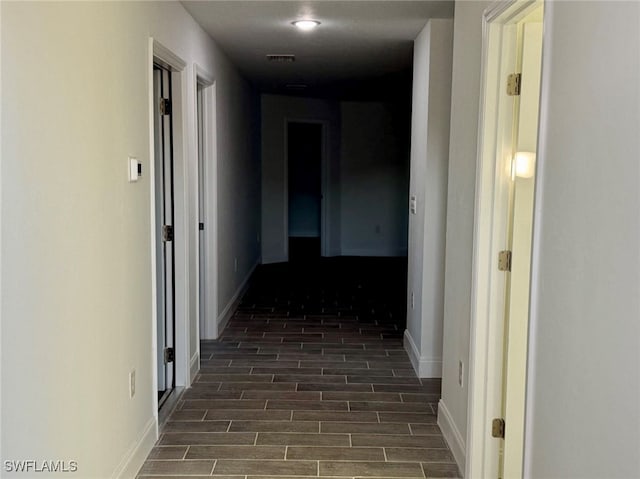 hallway with dark wood-type flooring