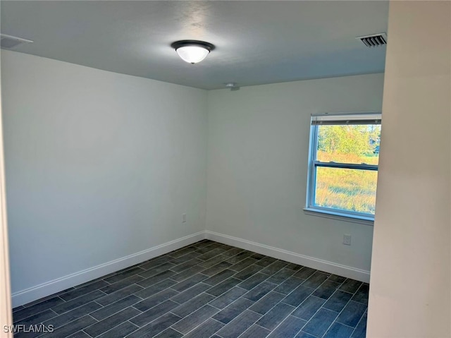 spare room with dark hardwood / wood-style floors