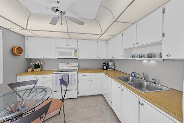 kitchen featuring ceiling fan, sink, white cabinets, and white appliances