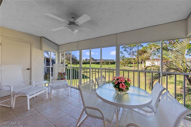 unfurnished sunroom featuring ceiling fan