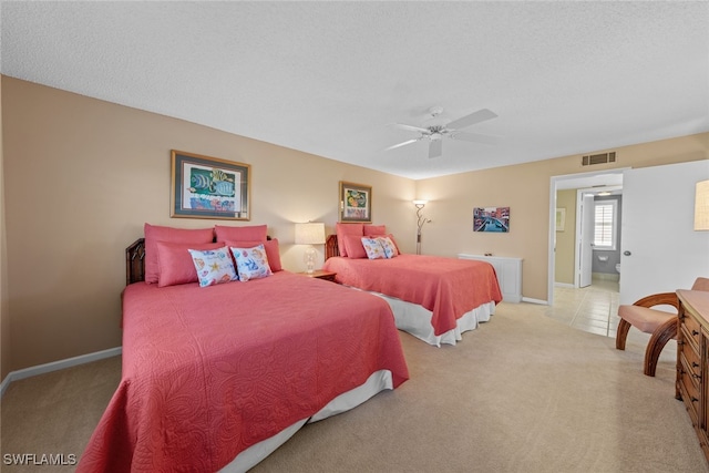 carpeted bedroom with ceiling fan and a textured ceiling