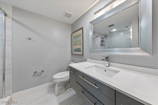 bathroom with a shower with door, vanity, and toilet