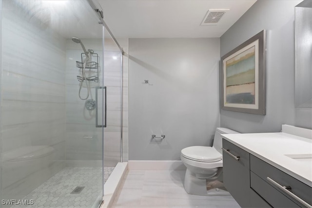 bathroom with vanity, toilet, and an enclosed shower