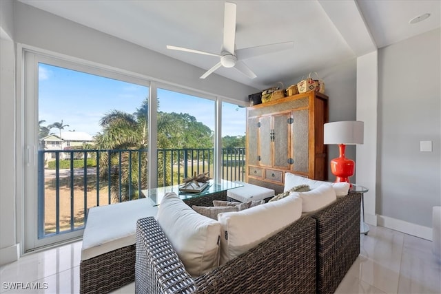 living room featuring ceiling fan and light tile patterned flooring