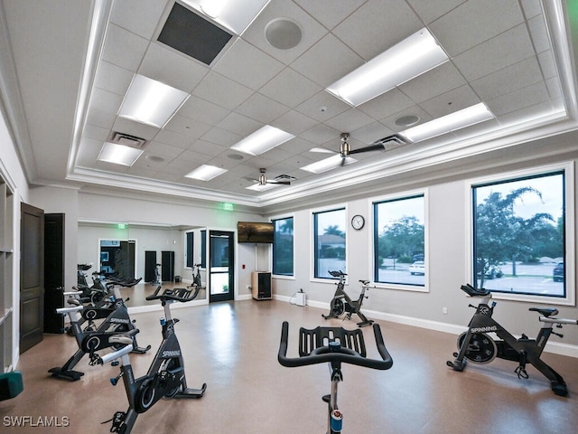 exercise room with a paneled ceiling and ornamental molding