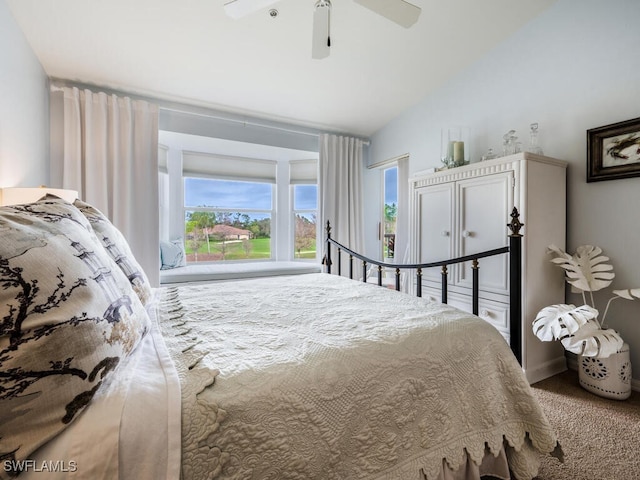 carpeted bedroom with ceiling fan and vaulted ceiling