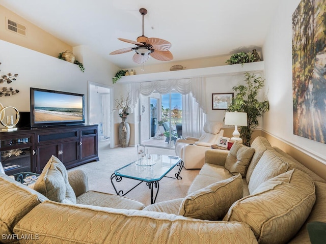 living room featuring light carpet, ceiling fan, and vaulted ceiling