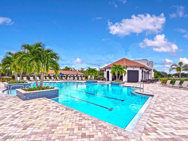 view of pool featuring a patio area and a jacuzzi