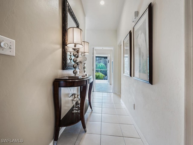 hall featuring light tile patterned flooring